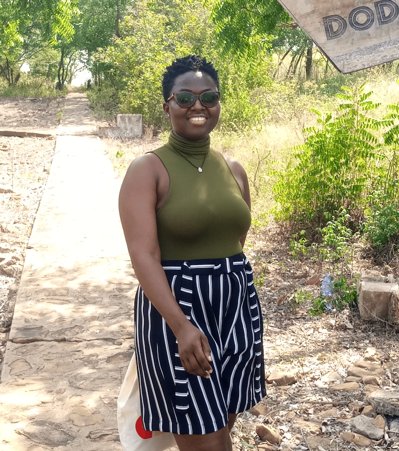 Vivian Navele smiling, seated in an outdoor setting